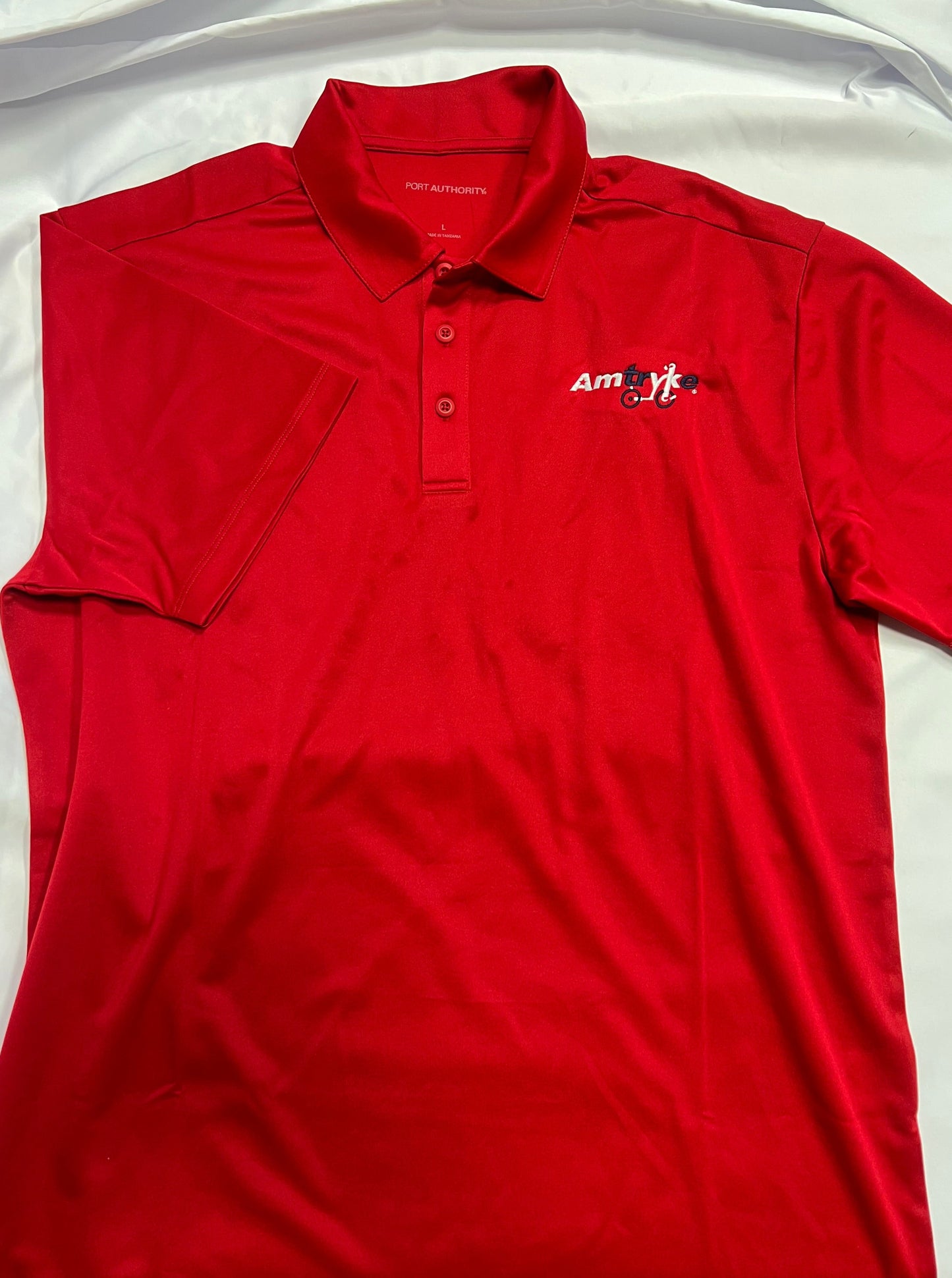 short sleeve polo style shirt with Amtryke logo on left