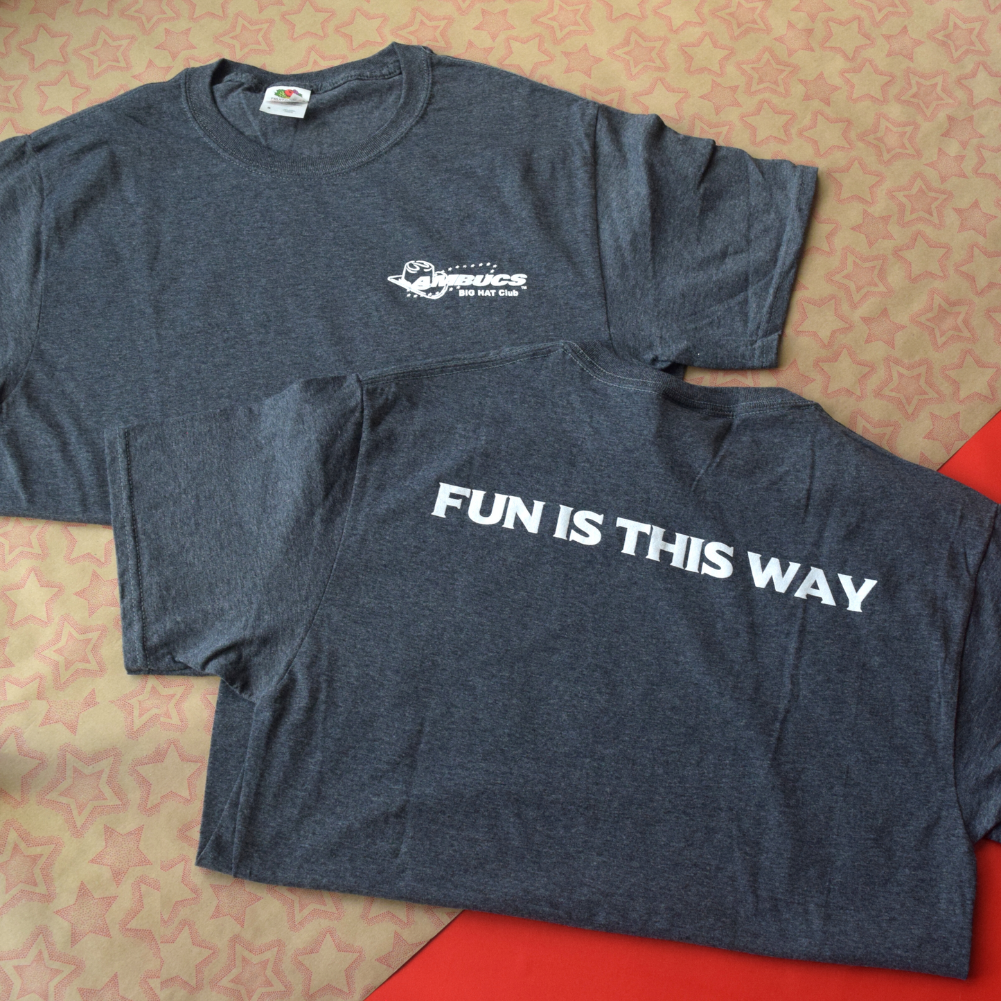 Dark grey t-shirt with Big Hat logo on front of shirt. Back of shirt has fun this way printed in white lettering