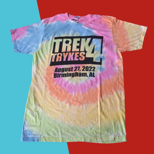Light blue, pink, orange, yellow and light green tie dyed t-shirt with the words trek 4 trykes, August 27, 2022 Birmingham, AL printed in black